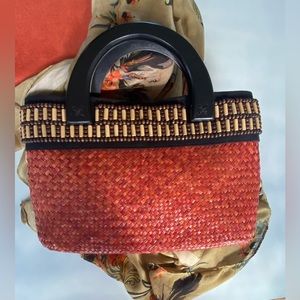 Vintage Hand bag straw with woodwork . Handles are wood and inside is red .